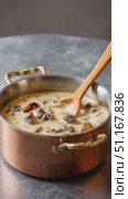 Warm mushroom soup simmering gently in copper pot, wooden spoon nearby, promising comfort against gray tabletop's muted backdrop. Стоковое AI-видео, аниматор Юрий Поздников / Фотобанк Лори