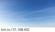 Clear early sky displaying a soothing gradient of blue hues with wispy clouds. Стоковое фото, фотограф EugeneSergeev / Фотобанк Лори