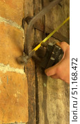 Man cutting padlock with hacksaw. Vintage wooden door in brick wall. He knocks the lock off with a hammer. Vertical video. Стоковое видео, видеограф Vadzim Yakubovich / Фотобанк Лори