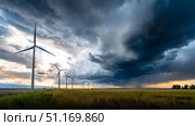 Dark shelf cloud preceding a severe thunderstorm at a wind turbine park. Beautiful thunderstorm black clouds and clouds hanging over the ground. Стоковое AI-изображение, AI-художник ALLA YURTAYEVA / Фотобанк Лори
