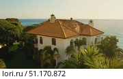 Discover a stunning villa with breathtaking ocean views and vibrant palm trees at golden hour. Стоковое AI-видео, аниматор Данила Большаков / Фотобанк Лори