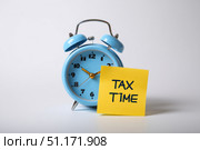 Tax season. Taxation. Text Tax Time on a Sticker, Calculator and a Clock. Paperwork, financial research, report. Calculation tax. Personal banking. Finance. Planning budget. Calculating expense. Стоковое AI-изображение, AI-художник Марина Демидюк / Фотобанк Лори