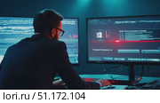 An expert reviews intricate digital information displayed on large monitors in an advanced tech workspace. Стоковое AI-видео, аниматор Данила Большаков / Фотобанк Лори