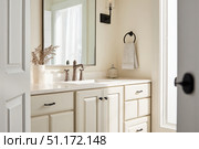 Grey bathroom vanity with white walls, mirror and marble countertop, black hardware. Clean aesthetic background. Home interior room design. Gray cabinet in a bathroom. Стоковое AI-изображение, AI-художник Марина Демидюк / Фотобанк Лори