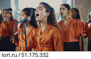 A talented group of young singers captivates the audience with their vocal performance at a community gathering. Стоковое AI-видео, аниматор Данила Большаков / Фотобанк Лори