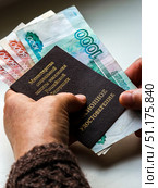 Woman's hands holding russian pension certificate and russian rubles. Russian translation - Ministry of Social Protection of Population of Russian Federation. Pension Certificate. Стоковое фото, фотограф Denis Vostrikov / Фотобанк Лори