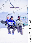 Sheregesh, Russia, 3 February 2017, Snowboarder skier climb up mountain gondola. Редакционное фото, фотограф Spirit River / Фотобанк Лори