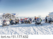 Sheregesh, Russia, 7 January 2017, Snowboarders skiers sit on snowmobile. Редакционное фото, фотограф Spirit River / Фотобанк Лори