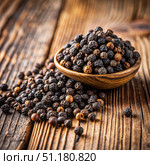 Black Peppercorns Scattered on a Wooden Surface. Generative AI. Стоковое AI-изображение, AI-художник Roman Zavorotny / Фотобанк Лори