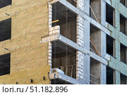 Installation of external wall thermal insulation with rock wool. Exterior passive house wall heat insulation with mineral wool. Insulation facade of multistory residential building. Energy efficiency. Стоковое фото, фотограф Данила Большаков / Фотобанк Лори
