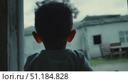 A young child gazes wonderingly at something intriguing outside an old building in a tranquil setting at dusk. Стоковое AI-видео, аниматор Данила Большаков / Фотобанк Лори