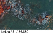 Top view of waves and red rocks in sea. Стоковое видео, видеограф Михаил Коханчиков / Фотобанк Лори