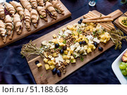 Buffet hotel restaurant, coffee break event food on wooden plates stand on table. Стоковое фото, фотограф Spirit River / Фотобанк Лори