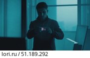 A shadowy figure navigates an empty office building shrouded in blue light during the early morning, creating an atmosphere of suspense and intrigue. Стоковое AI-видео, аниматор Данила Большаков / Фотобанк Лори