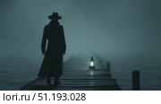 Mysterious figure in long coat walks along foggy pier illuminated by lantern light. Стоковое AI-видео, аниматор Данил Руденко / Фотобанк Лори