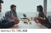 Four professionals engage in a focused discussion over drinks and snacks while enjoying a scenic backdrop in a bright office space. Стоковое AI-видео, аниматор Данила Большаков / Фотобанк Лори