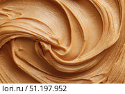 Creamy peanut butter spread swirl surface. Closeup, full frame. Crunchy Peanut butter background. American cuisine traditional product. Appetizing textured smears. Food paste from ground roasted nuts. Стоковое AI-изображение, AI-художник Марина Демидюк / Фотобанк Лори