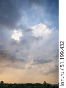 Dramatic thunderous sunset sky with dark huge rain clouds over forest. Стоковое фото, фотограф irisff / Фотобанк Лори