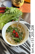 On a black background, flat lay, Vietnamese fo bo soup with quail egg, meat and noodles. Стоковое фото, фотограф Zita Khasanova / Фотобанк Лори
