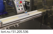conveyor at a confectionery factory coating wafer plates with chocolate mass and assembling wafers. Стоковое видео, видеограф Алексей Сергеев / Фотобанк Лори