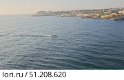 View from the cruise ship approaching Malta. The escort ship follows the cruise liner. Стоковое видео, видеограф EStarodubov / Фотобанк Лори