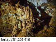 A wild cave inside. Stalactites and stalagmites. Speleology and surveys. Стоковое фото, фотограф Наталия Кирсанова / Фотобанк Лори