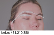 An Innovative and Elegant Eyebrow Styling Technique Utilizing Cream Application for Beauty. Стоковое видео, видеограф Olesia Kondrateva / Фотобанк Лори
