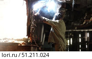 a welder repairs a huge turbine at a thermal power plant sparks fly from the welding machine. Стоковое видео, видеограф Алексей Сергеев / Фотобанк Лори