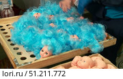 production of dolls at the toy factory hair extensions and coloring of blanks. Стоковое видео, видеограф Алексей Сергеев / Фотобанк Лори