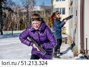 Krasnoyarsk, Russia, 7 March 2017, Children play paintball outside park winter. Редакционное фото, фотограф Spirit River / Фотобанк Лори