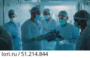 Medical professionals in protective equipment actively engage in patient care and safety protocols at a hospital amidst the pandemic. Стоковое AI-видео, аниматор Данила Большаков / Фотобанк Лори