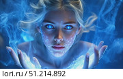 A young girl channels vibrant blue energy, creating mystical patterns with her hands in an enchanting nighttime atmosphere filled with magic. Стоковое AI-видео, аниматор Данила Большаков / Фотобанк Лори