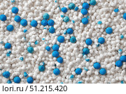 White cat litter round particles surface with small blue colored particles, top view. Granules of pet white-gray litter background. Dog litter texture backdrop with small dots. Flat lay, copy space. Стоковое AI-изображение, AI-художник Марина Демидюк / Фотобанк Лори