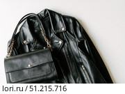 Black leather jacket with zippers and pockets and black leather stylish bag. Modern outerwear. Close-up. Fashion background. Autumn urban street clothes. Fashionable concept. Women's casual day outfit. Стоковое AI-изображение, AI-художник Марина Демидюк / Фотобанк Лори