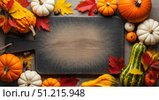 Fall harvest background with diverse pumpkins and gourds around cutting board, autumn food mockup with empty copy space for thanksgiving or halloween recipe. Стоковое AI-изображение, AI-художник Павел Муравьев / Фотобанк Лори