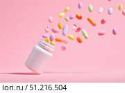Vitamin and health supplement white blank bottle with colorful pills flying out on a pink background. Flat lay, top view. Space for text. Bottle of various types multivitamins and tablets composition. Стоковое AI-изображение, AI-художник Марина Демидюк / Фотобанк Лори