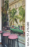 This vibrant street cafe in Havana features a wooden table adorned with tasty local food and refreshing drinks, set against a backdrop of vintage cars and colorful buildings under a clear sky Restaurant with sea in the background, Havana Bay, Havana, Cuba. Стоковое видео, видеограф Zita Khasanova / Фотобанк Лори