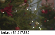 The lens focuses and the lights on the sides turn into Christmas tree lights during a festive New Year's celebration. Close up. Стоковое видео, видеограф Strunov David / Фотобанк Лори