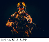 Special operations forces soldier wearing mask, armed with submachine gun, on black background. Oleg Zabielin / Stocktrek Images/TASS. Стоковое фото, агентство ТАСС / Фотобанк Лори