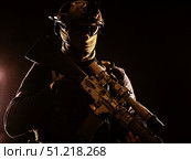 Disguised marksman holding sniper rifle with optical sight and silencer. Oleg Zabielin / Stocktrek Images/TASS. Стоковое фото, агентство ТАСС / Фотобанк Лори