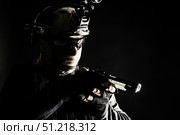 Police SWAT team fighter aiming pistol while sneaking in the darkness. Oleg Zabielin / Stocktrek Images/TASS. Стоковое фото, агентство ТАСС / Фотобанк Лори