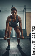 Muscular woman lifting heavy barbell during intense deadlift workout, displaying athletic prowess in dark fitness center with glistening, toned physique. Стоковое AI-изображение, AI-художник Юрий Поздников / Фотобанк Лори