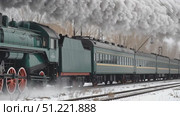 Vintage steam locomotive pulling passenger cars, belching white smoke across snowy landscape, evoking classic railway journey through winter scenery. Стоковое AI-видео, аниматор Юрий Поздников / Фотобанк Лори