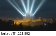 Luminous light rays piercing through dense urban fog, highlighting towering skyscraper silhouette during nighttime metropolitan atmosphere. Стоковое AI-видео, аниматор Юрий Поздников / Фотобанк Лори