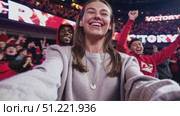 Jubilant woman taking selfies with diverse crowd cheering after victory, celebrating triumph with energetic, collective excitement inside packed stadium. Стоковое AI-видео, аниматор Юрий Поздников / Фотобанк Лори