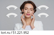 Professional skincare expert applying advanced facial lifting technique, drawing arrows on smooth complexion, revealing anti aging treatment against minimalist background. Стоковое AI-видео, аниматор Юрий Поздников / Фотобанк Лори