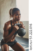 Muscular woman performing intense kettlebell squats, demonstrating fitness prowess with powerful movements, sweating during challenging workout in modern gym setting. Стоковое AI-видео, аниматор Юрий Поздников / Фотобанк Лори