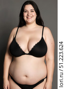 Happy plus size model in black lingerie, fat woman on gray background, obese body. Стоковое AI-изображение, AI-художник Станислав Тарко / Фотобанк Лори