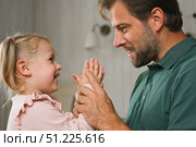Happy Father Playing with Daughter. Three Years Baby Smiling, Laughing, Looking at Daddy. Man Showing Affection to Child. Candid Real Emotion. Beard Dad and Little Kid Girl. Authentic Family Lifestyle. Стоковое фото, фотограф Марина Демидюк / Фотобанк Лори