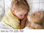 Peaceful adorable baby sleeping on a bed at home. Slumbering little child. Two years old girl sleeps peaceful at domestic room interior background. Serene dream. Cute face close up. Deep kid slumber. Стоковое фото, фотограф Марина Демидюк / Фотобанк Лори